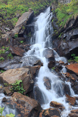 Fototapeta na wymiar Beautiful waterfall in the mountains during the summer.