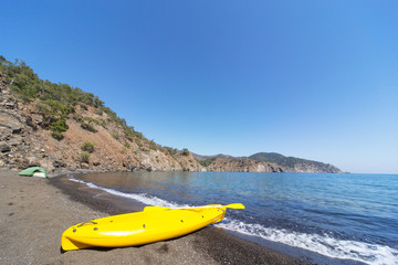 Camping with kayaks on the beach in summer.