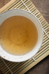 Jasmine and green tea in a traditional style ceramic bowl top down view