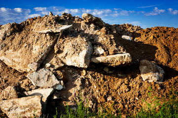 Geological soil cut on blue sky background.