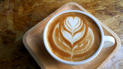 Cup of coffee with heart flower painted on foam