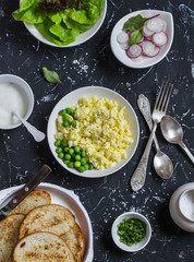 Breakfast sandwiches with egg's scramble, radish and green peas. Delicious healthy food