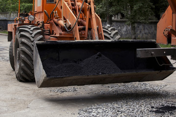 asphalt in a ladle of excavator