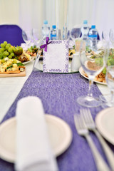 Beautiful wedding restaurant for marriage. White decor for bride and groom. Colorful decoration for celebration. Beauty bridal interior. Bouquet, food and flowers in hall