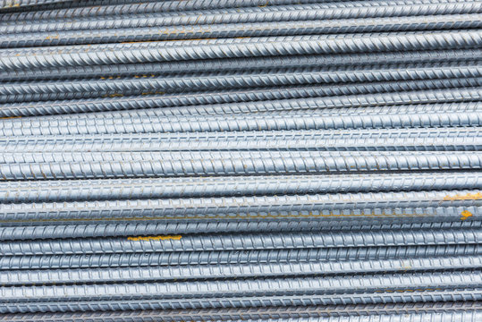 The deform bar, the steel deform bar pile on the construction site. Close-up the corrosion on the steel deform bar which cause of rust.