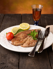 Grilled tuna steak on a white plate with aromas