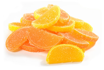 Heap of orange and lemon candy slices on a white