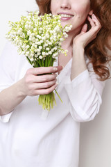 Woman holding bouquet of lily of the valley flowers