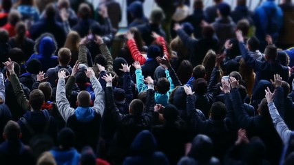 Young fans supporting favorite football team during a match at the stadium