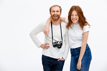 Fototapeta premium Redhead photographer dressed in white jacket standing near redhe