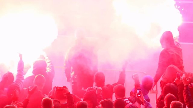 Hooligans using burning flares, smoke bombs at tribunes during football game