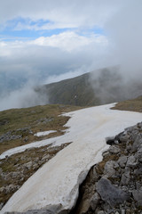 Snow, stones and clouds on Czerwone Wierchy in Tatra mountains