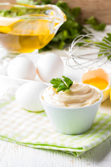 Fresh homemade Mayonnaise and ingredients on white background