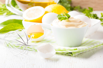 Obraz na płótnie Canvas Fresh homemade Mayonnaise and ingredients on white background