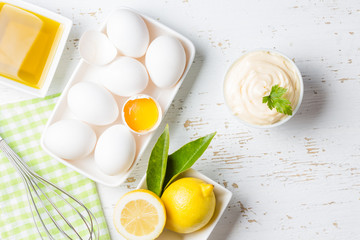 Fresh homemade Mayonnaise and ingredients on white background