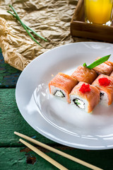 Rolls on white plate and beverage.