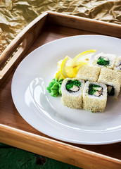 Rolls on white plate. Wooden tray.
