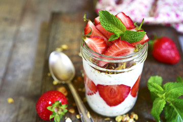 Healthy layered dessert with chia pudding,granola and strawberry