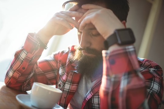 Close-up of upset hipster at cafe