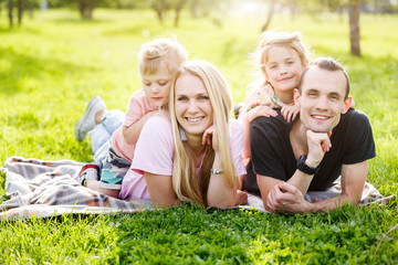 Fototapeta premium Rodzina bawić się w parku na trawie