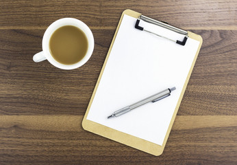 Blank Clipboard and a cup of coffee on wood