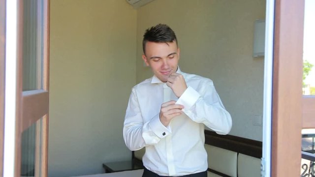 Stylish handsome man cufflinks boutonniere indoor