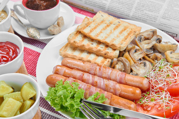 Fried sausages wrapped in bacon