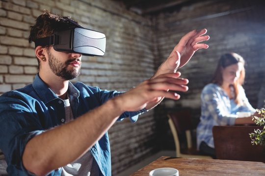 Man enjoying virtual headset at coffee shop