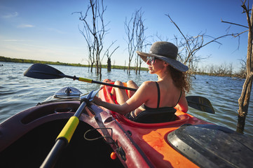 a beautiful young woman in a kayak
