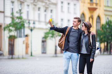 Selfie photo by caucasian couple traveling in Europe. Romantic travel woman and man in love smiling happy taking self portrait outdoor during vacation holidays in Prague