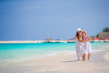 Little girl and young mother during beach vacation