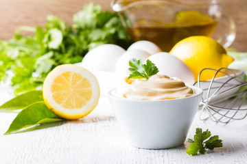 Fresh homemade Mayonnaise and ingredients on white background