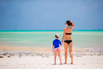 Happy family during summer vacation on white beach