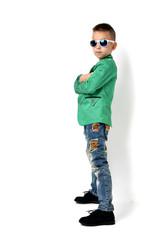 Fototapeta na wymiar Fashion beautiful little boy in sunglasses blue cloth jeans stan
