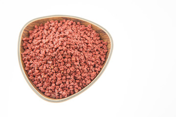Obraz na płótnie Canvas Annatto seeds - annatto (annatto) seeds in a container