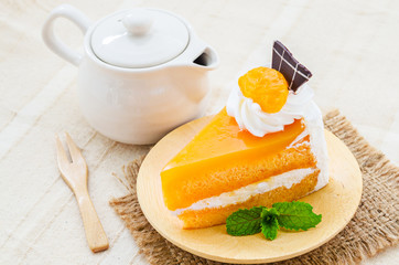 orange cake with chocolate and wipping cream topping.