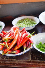 fresh red chilli in white and blue zinc bowl