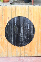 Wooden board with black circle in the center