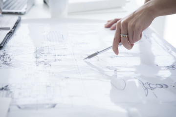 Women are pointing to the design drawing with a pen