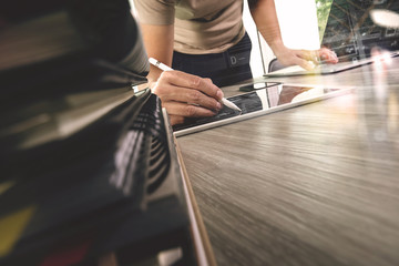 designer hand working with digital tablet and laptop computer an