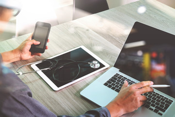 doctor hand working with modern digital tablet and laptop comput