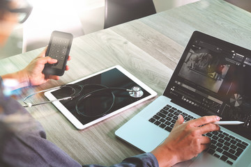 Doctor working with digital tablet and laptop computer with smar