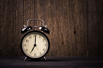 Alarm clock on wood background
