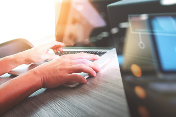 Double exposure of business man hand working on blank screen lap