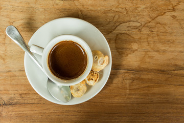 White cup of coffee on white brown table in cafe with copy space