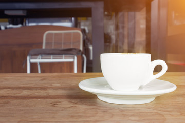cup of coffee with smoke on wooden table in cafe.