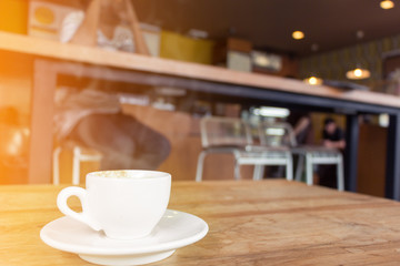 cup of coffee with smoke on wooden table in cafe.