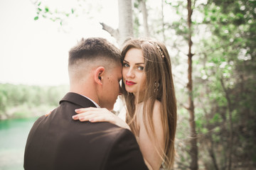 Kissing wedding couple in spring nature close-up portrait