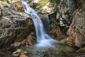 Naklejka na ściany i meble Waterfall over limestone rocks in the Carpathians