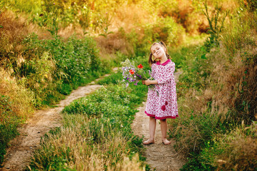 Little girl with a bouquet of wild flowers